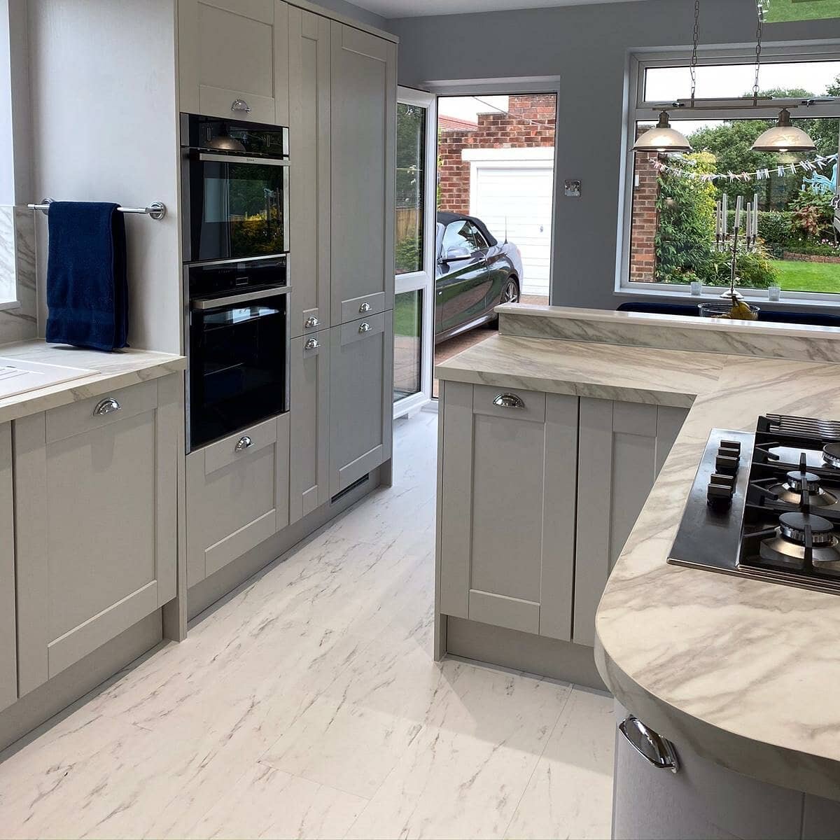 English Shaker kitchen with marble floor and dining nook, Wirral